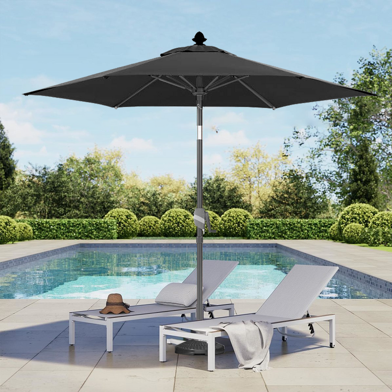 Patioslife 8ft black patio umbrella shading pool loungers in a landscaped backyard pool area