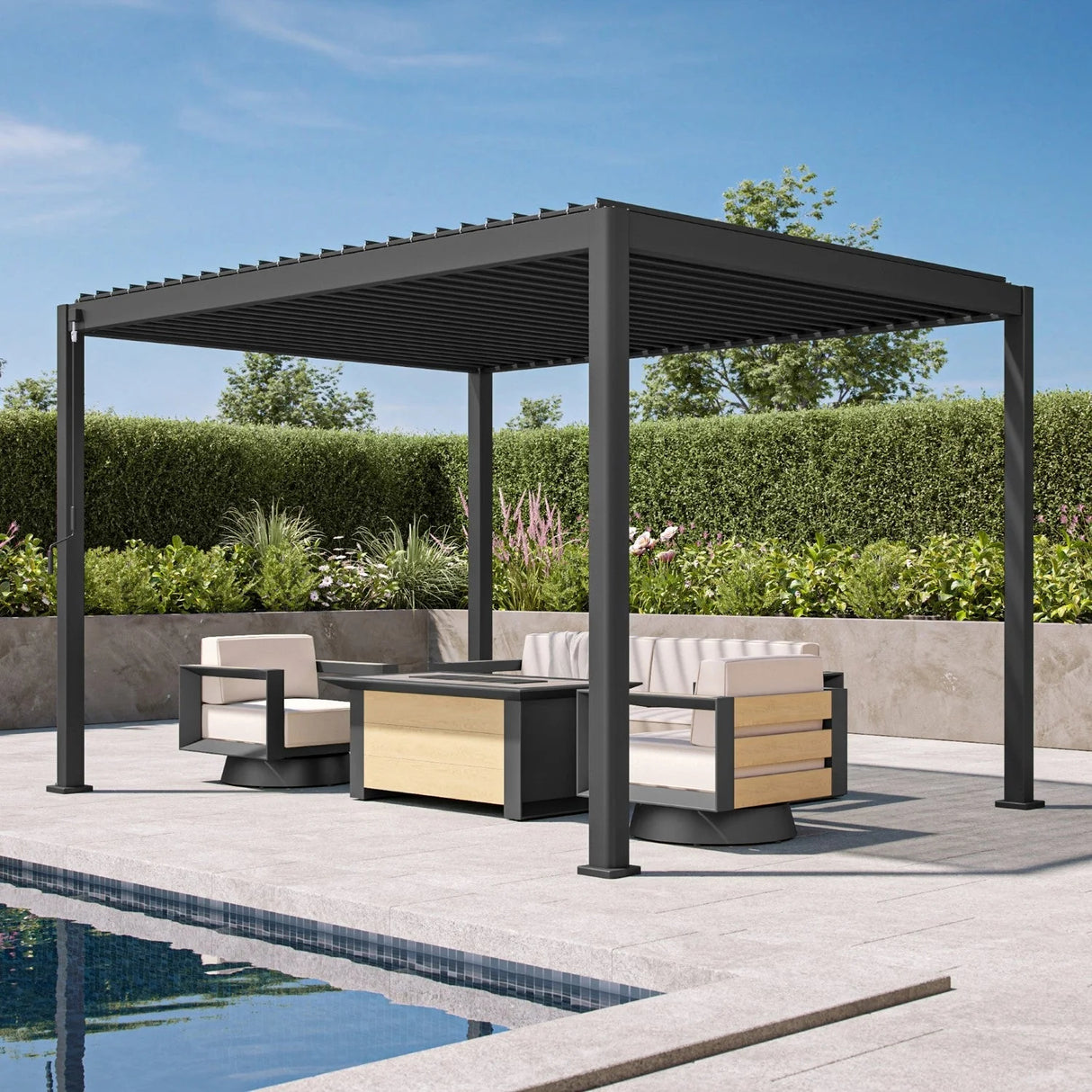Patioslife Atlantic charcoal pergola shading outdoor lounge chairs and fire table beside a pool and garden hedge