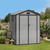 Patioslife YardVault 6x4ft resin garden storage shed with double doors, built-in floor and side window in a landscaped backyard