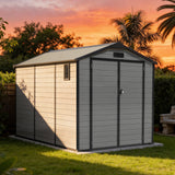 Patioslife YardVault 8x10ft resin garden storage shed with built-in floor, lockable double doors and side window in a sunset backyard