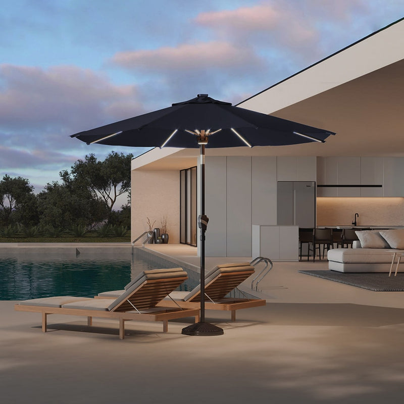 Patioslife 8ft black patio umbrella with LED lights beside pool loungers on a modern evening patio