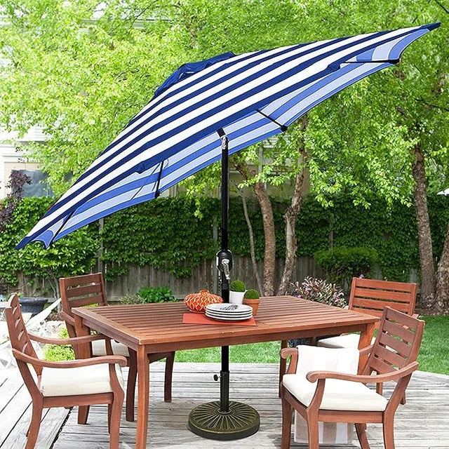 Patioslife Outdoor Market Breeze blue and white striped patio umbrella over an outdoor dining table on a backyard deck