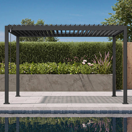 Patioslife Atlantic 10×20ft charcoal louvered pergola with open roof beside a pool, hedge wall and garden plants