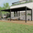 Patioslife Atlantic charcoal aluminium pergola covering a modern backyard deck with sofa, dining set and garden lawn