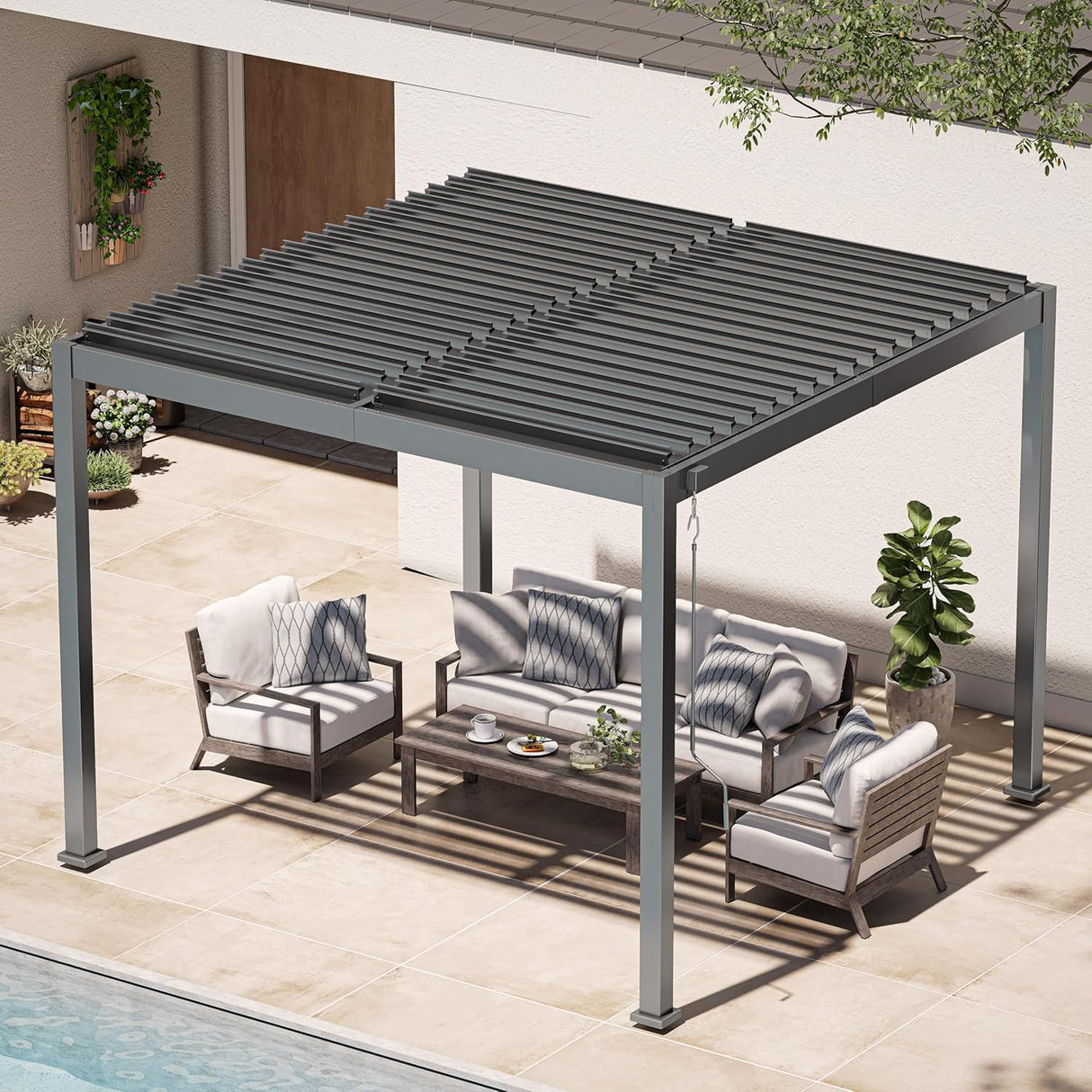 Patioslife Atlantic charcoal aluminum louvered pergola with adjustable slat roof, shading an outdoor lounge set on a tiled patio beside a pool and modern house