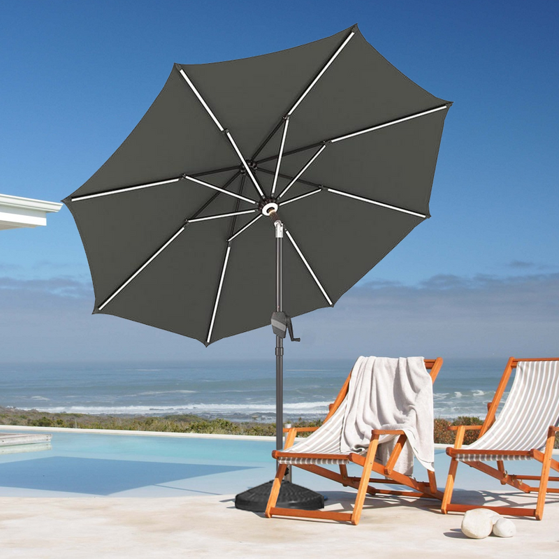 Patioslife 8ft charcoal patio umbrella by an ocean view pool deck with striped lounge chairs