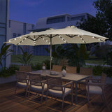 Patioslife Horizon 15 x 9 ft cream double-sided patio umbrella with LED lights over an outdoor dining set on a modern deck at night