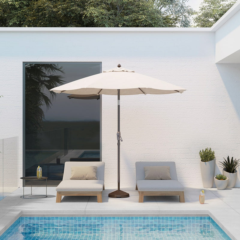Patioslife 8ft cream patio umbrella beside a modern white pool patio with lounge chairs and potted plants