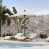 Patioslife 8ft cream patio umbrella shading pool loungers against a stone wall with tropical plants
