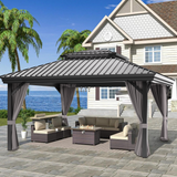 Patioslife Haven 10' x 12' grey hardtop pergola gazebo with double vented roof and side curtains, set on a stone patio beside a coastal home with ocean view and outdoor sofa seating