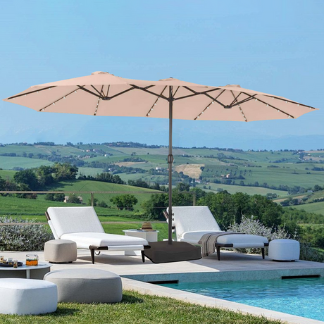 Patioslife Horizon 15 x 9 ft double-sided patio umbrella with LED lights and base, shading poolside lounge chairs with countryside views